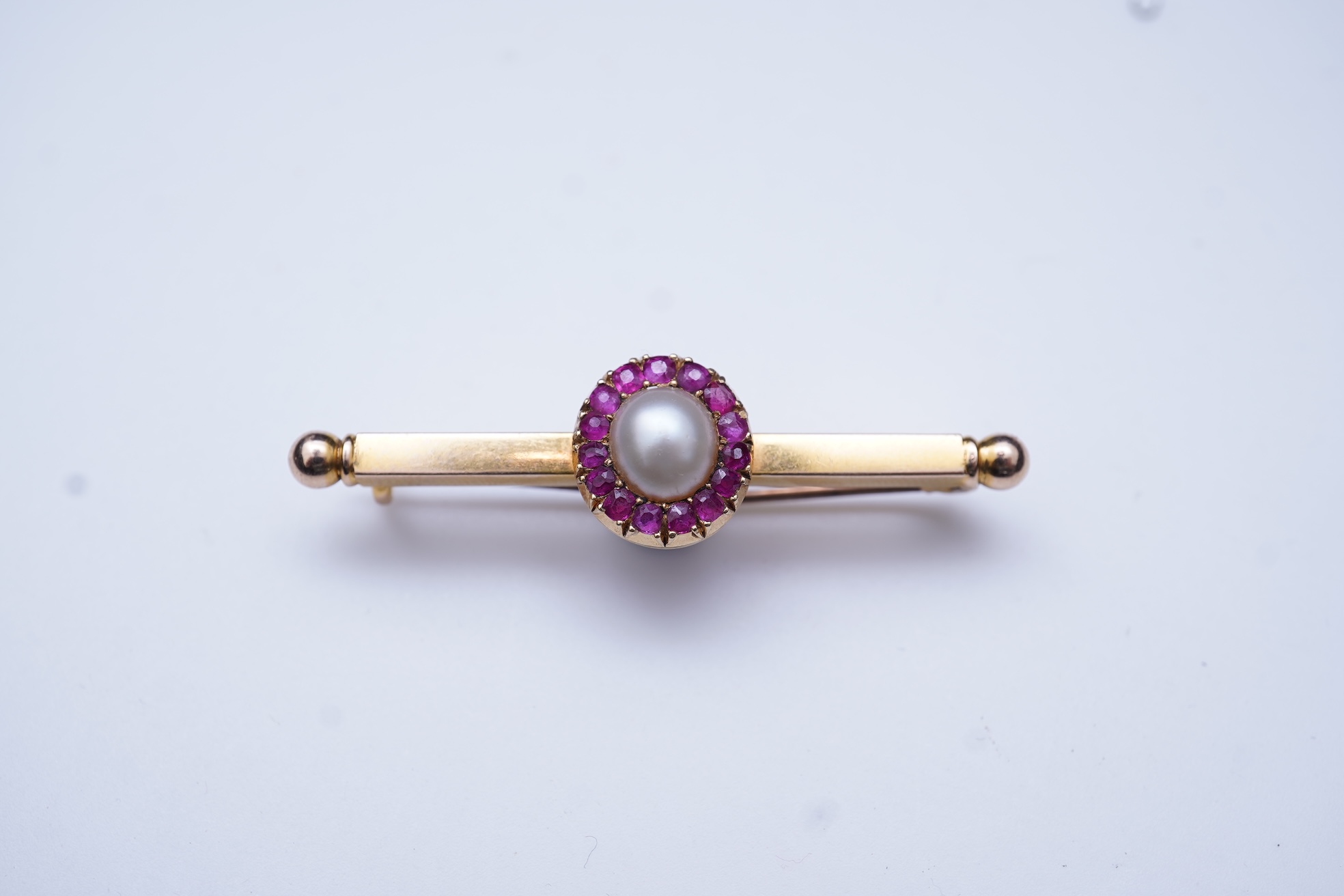 A pearl and ruby bar brooch, 19th century